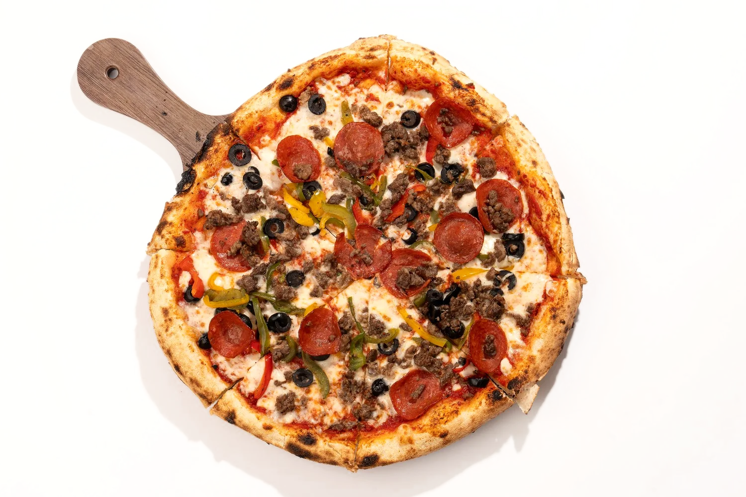 Italian Pizza Restaurant super supreme on a wooden peel